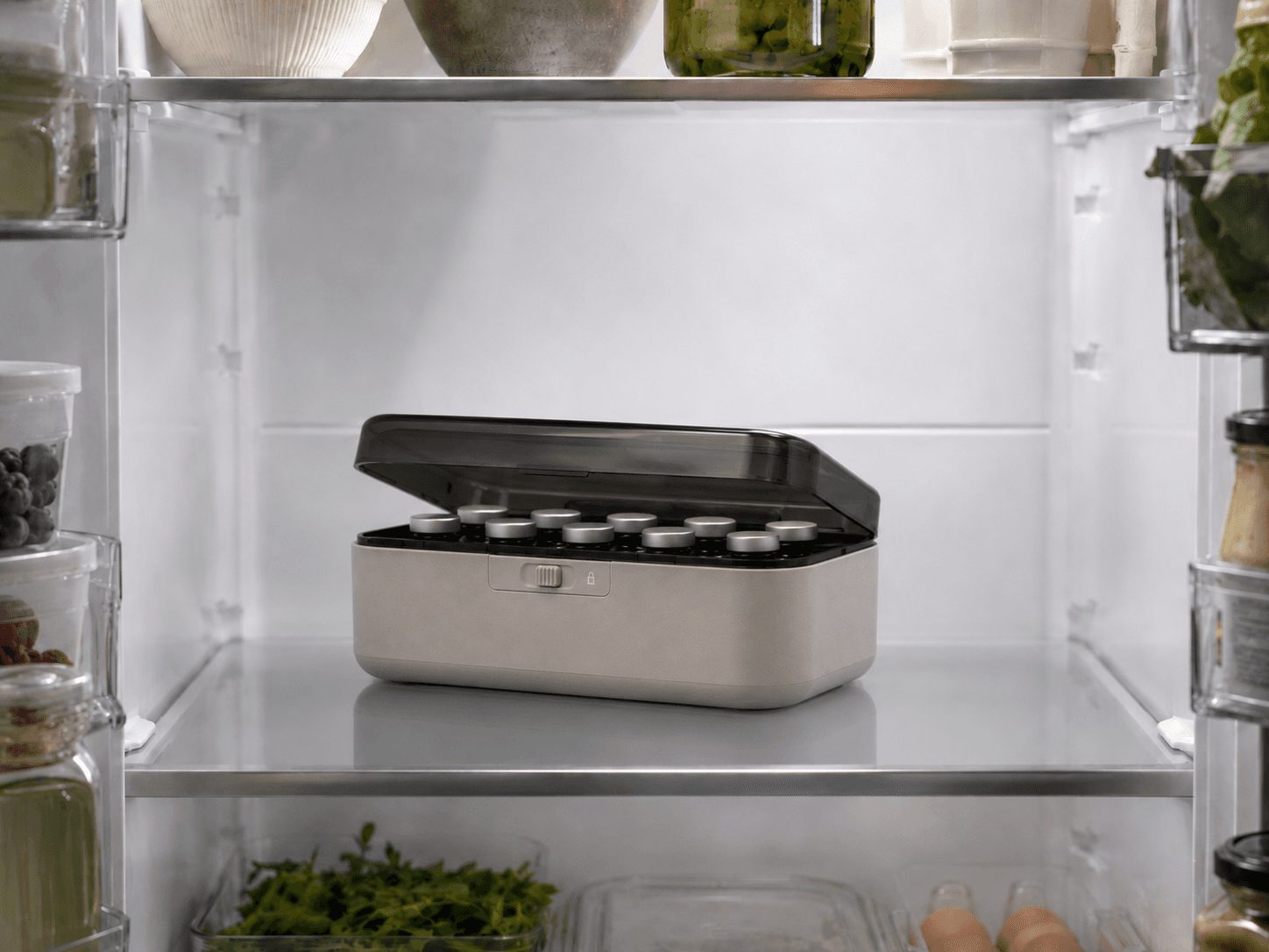 The KOLD case open on a refrigerator shelf, twelve capped vials seated in its insert