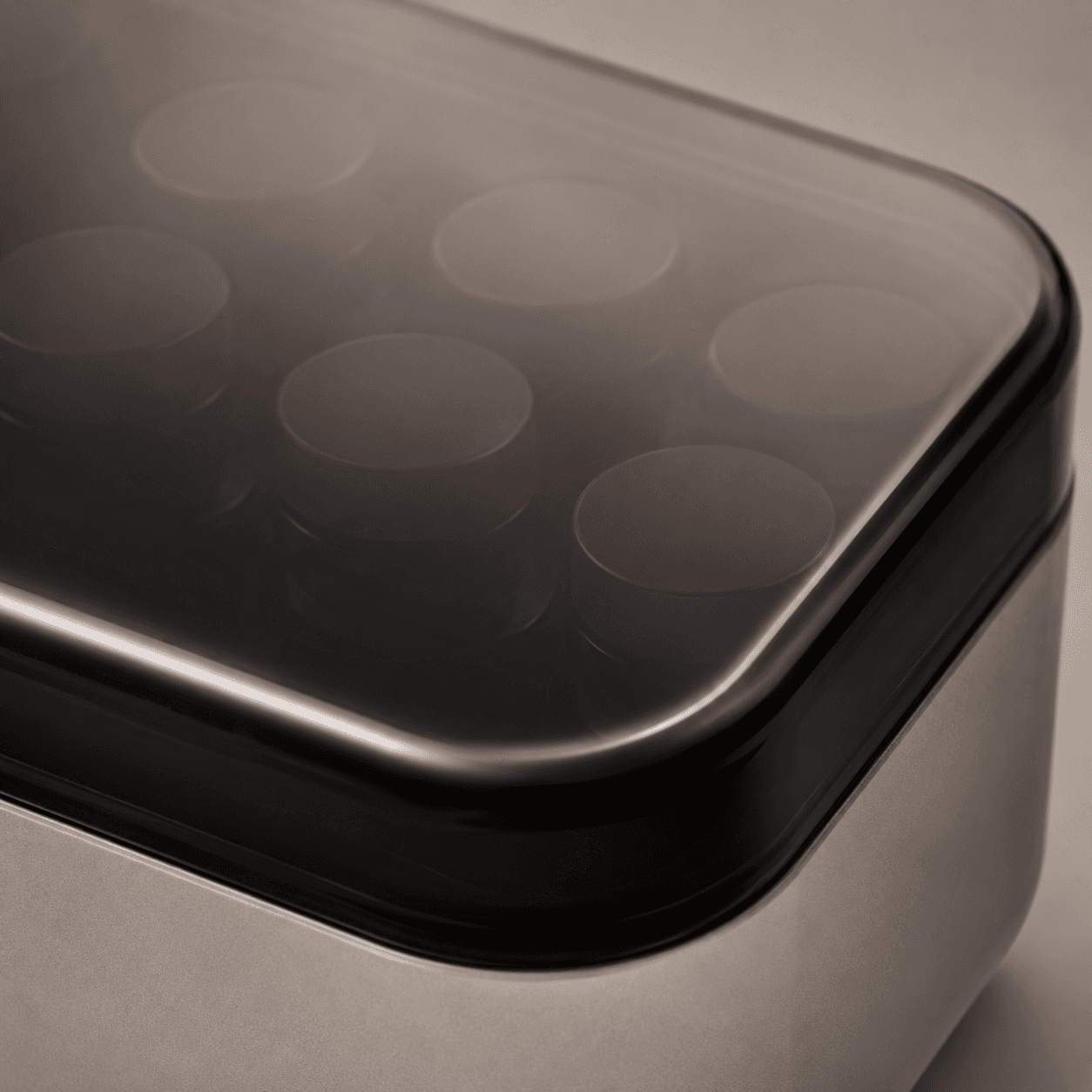 Close-up of the KOLD smoked translucent lid over rows of capped vials
